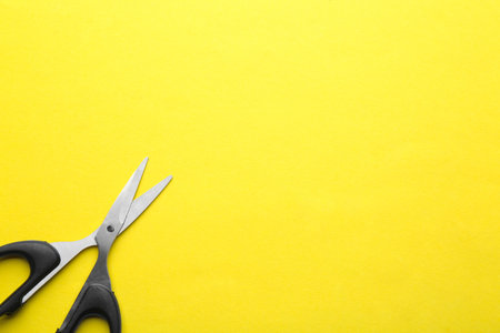 Pair of sharp scissors on color background, top view. Space for textの写真素材