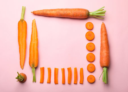 Flat lay composition with fresh carrots on color background. Space for textの写真素材