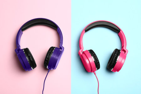 Stylish modern headphones on color background, flat layの写真素材