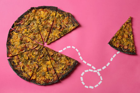 Slice connected with black pizza by dotted line on color background, flat layの写真素材