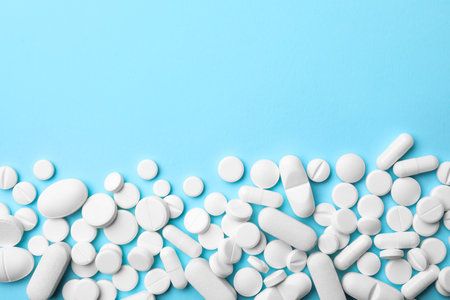 Different pills on color background, top view. Space for text