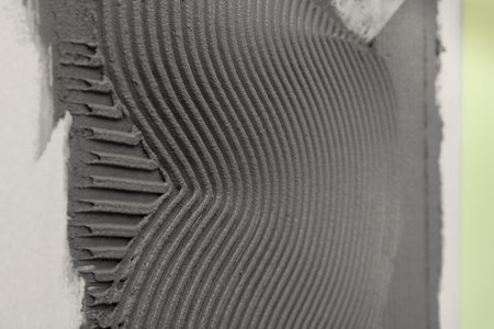 Lined concrete on wall, closeup with space for text. Tile installationの写真素材