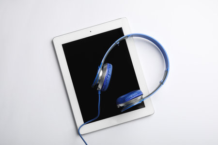 Stylish headphones and modern tablet on white background, top viewの写真素材
