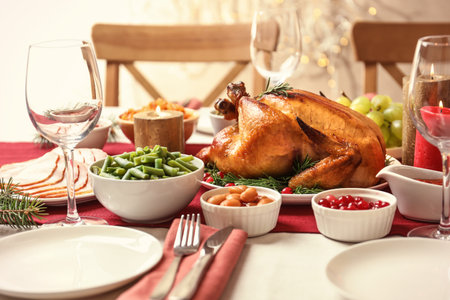 Traditional festive dinner with delicious roasted turkey served on tableの写真素材