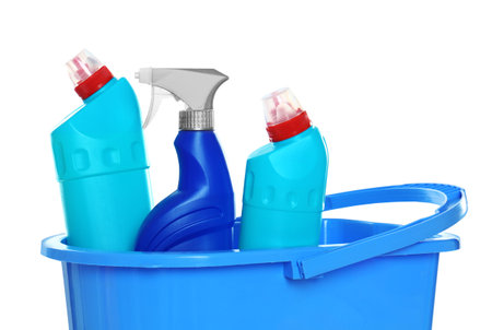 Plastic bucket with different cleaning products on white backgroundの写真素材
