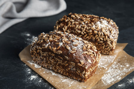 Fresh wholegrain bread on gray table, closeup