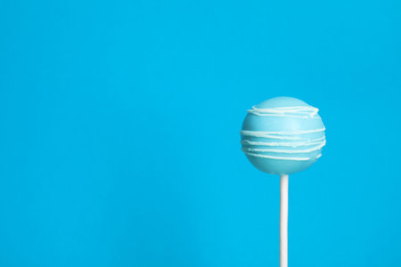 Bright delicious cake pop on color background. Space for textの写真素材