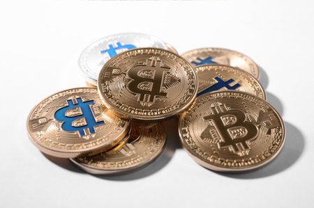 Gold and silver bitcoins on white background. digital currencyの写真素材