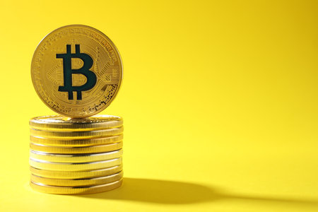 Stack of bitcoins on color background, space for text. digital currencyの写真素材