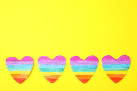 Top view of rainbow hearts on color background, space for text. gay symbol