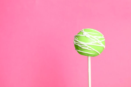 Bright delicious cake pop on color background. Space for textの写真素材
