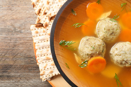 Bowl of Jewish matzoh balls soup on wooden table, closeupの写真素材