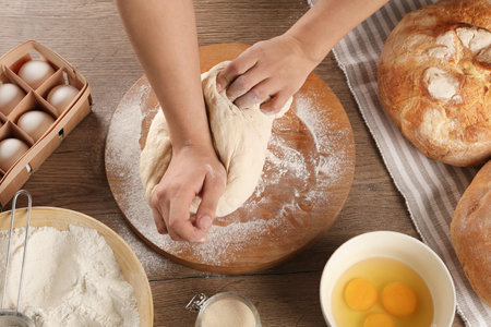 Female baker preparing bread dough at kitchen table, above viewの写真素材