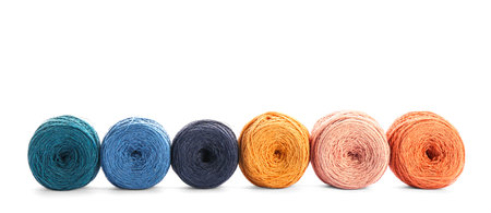 Clews of colorful knitting threads in row on white background