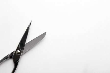 Pair of sharp scissors on white background