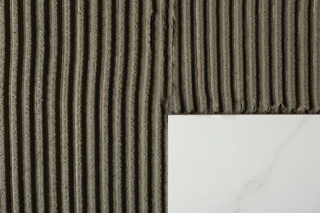 Adhesive mix and ceramic tiles, top view. Space for textの写真素材