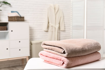 Clean folded towels on the table in the bathroom. Space for textの写真素材