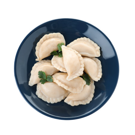 Plate of tasty dumplings served with parsley on white background, top viewの写真素材