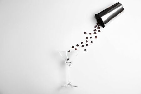 Flat lay composition with glass, coffee beans and shaker on white background. Alcohol cocktail recipe - Espresso Martiniの写真素材