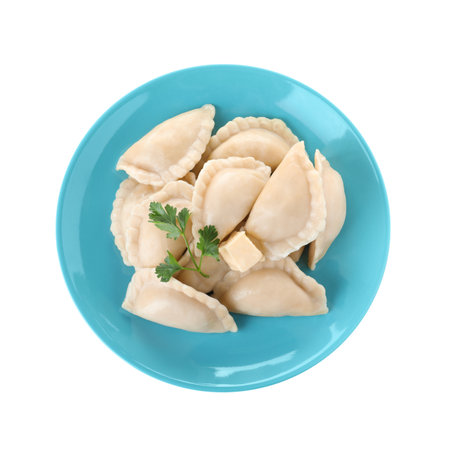 Plate of tasty dumplings served with parsley and butter on white background, top viewの写真素材