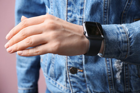 Woman wearing broken smart watch, closeup. repair service