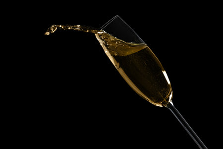 Glass of fizzy champagne on black background, closeup. Space for textの写真素材