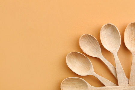 Flat lay composition with clean wooden spoons and space for text on color backgroundの写真素材