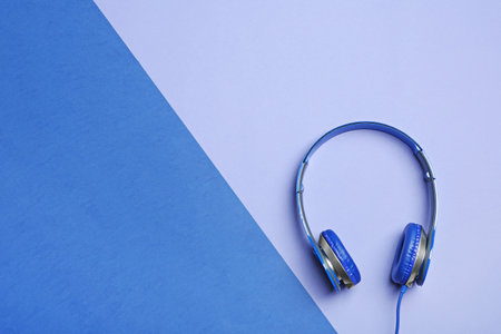 Stylish headphones on color background, top view. Space for textの写真素材