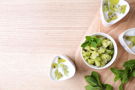 Flat lay composition of kiwi yogurt with ingredients on table, space for text. Multi-cooker recipeの写真素材