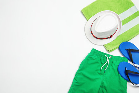 Flat lay composition with stylish male swim trunks on white background, space for text. beach objectsの写真素材