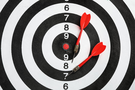 Dart board with color arrows, top view. Space for textの写真素材