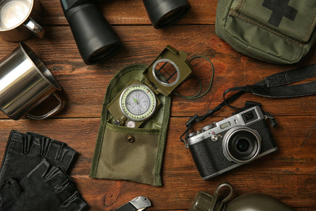 Flat lay composition with camping equipment on wooden backgroundの写真素材