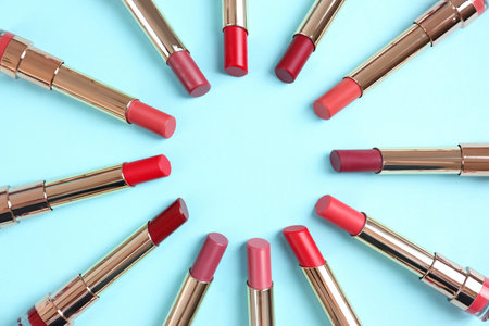 Flat lay composition with different stylish lipsticks on color background, space for textの写真素材