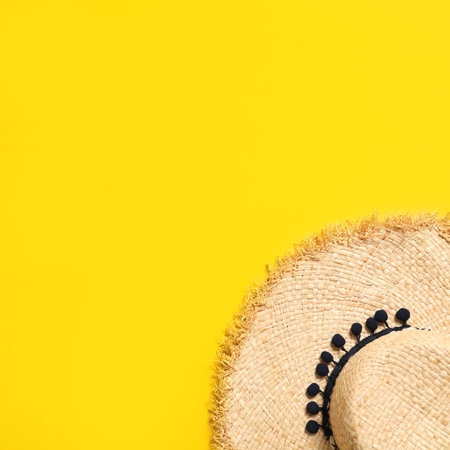 Stylish straw hat on color background, top view with space for text. beach accessoriesの写真素材