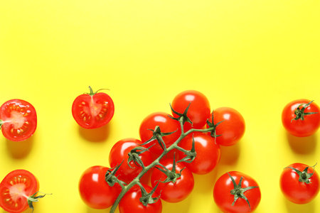 Flat lay composition with ripe cherry tomatoes on color background. Space for textの写真素材