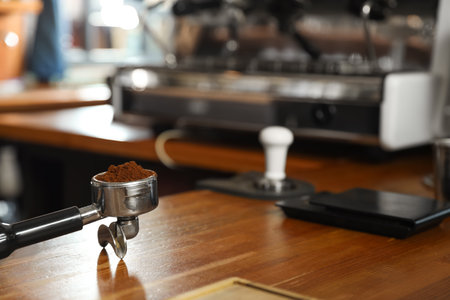 Portafilter with milled coffee on counter in bar. Space for textの写真素材