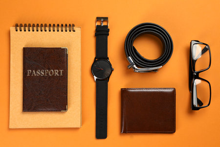 Flat lay composition with male accessories, passport and notebook on colorful backgroundの写真素材