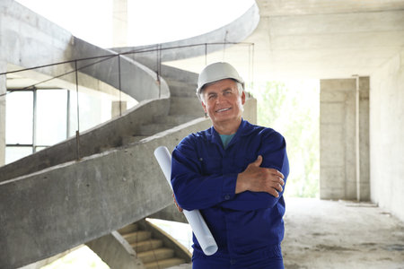 Professional engineer in safety equipment with designing at construction. Space for textの写真素材