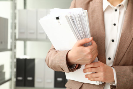 Female worker with documents in archive, closeupの写真素材
