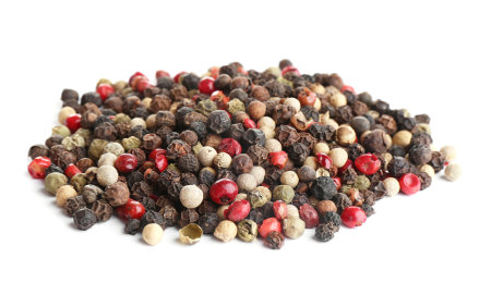 Heap of mixed peppercorns isolated on whiteの写真素材
