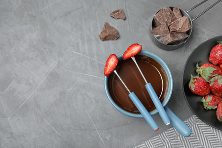 Flat lay composition with chocolate fondue and space for text on gray stone backgroundの写真素材