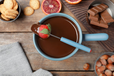 Flat lay composition with chocolate fondue on wooden backgroundの写真素材