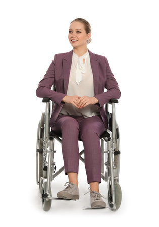 Beautiful young businesswoman in wheelchair isolated on whiteの写真素材
