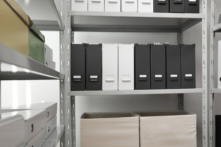 Folders and boxes with documents on shelves in archiveの写真素材