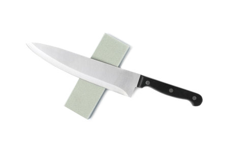 Chef's knife and grindstone isolated on white, top viewの写真素材