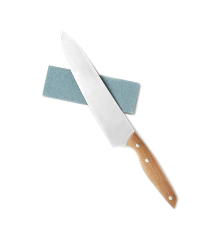 Chef's knife and grindstone isolated on white, top view