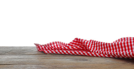 Red checkered cloth on wooden table against white background. Mockup for designの写真素材