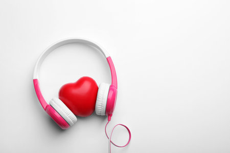 Decorative heart and modern headphones on white background, top viewの写真素材