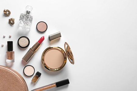 Cosmetic bag and different luxury makeup products on white background, top viewの写真素材