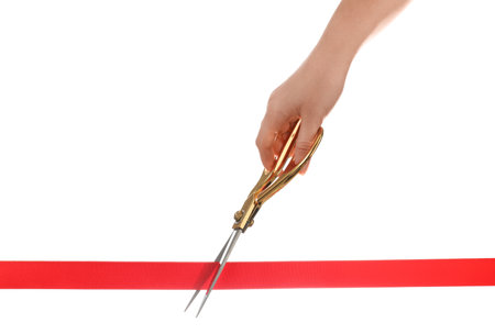 Woman cutting red ribbon with scissors on white background. traditional ceremony